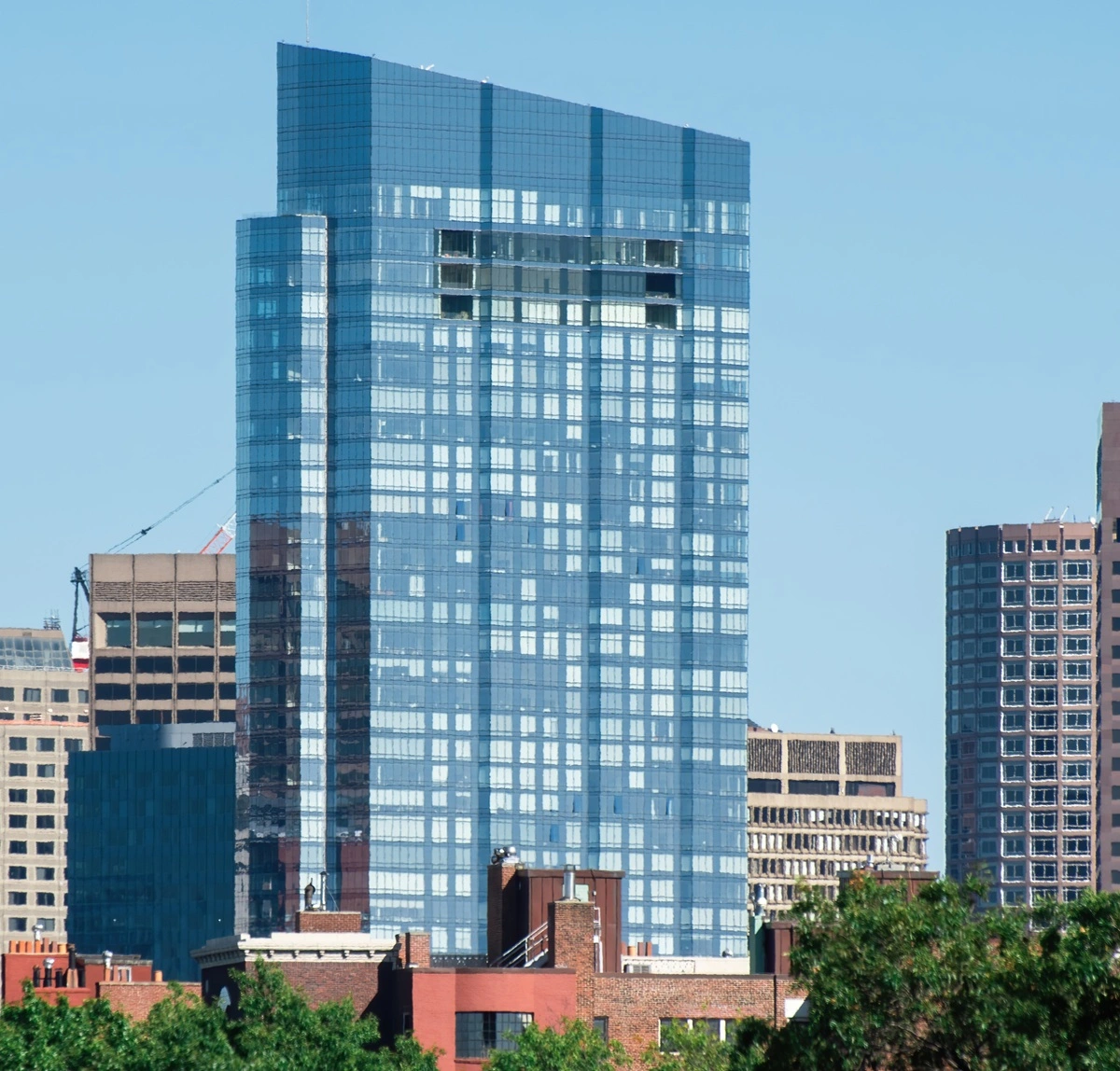 modern-skyscraper-with-glass-facade-greenery-around