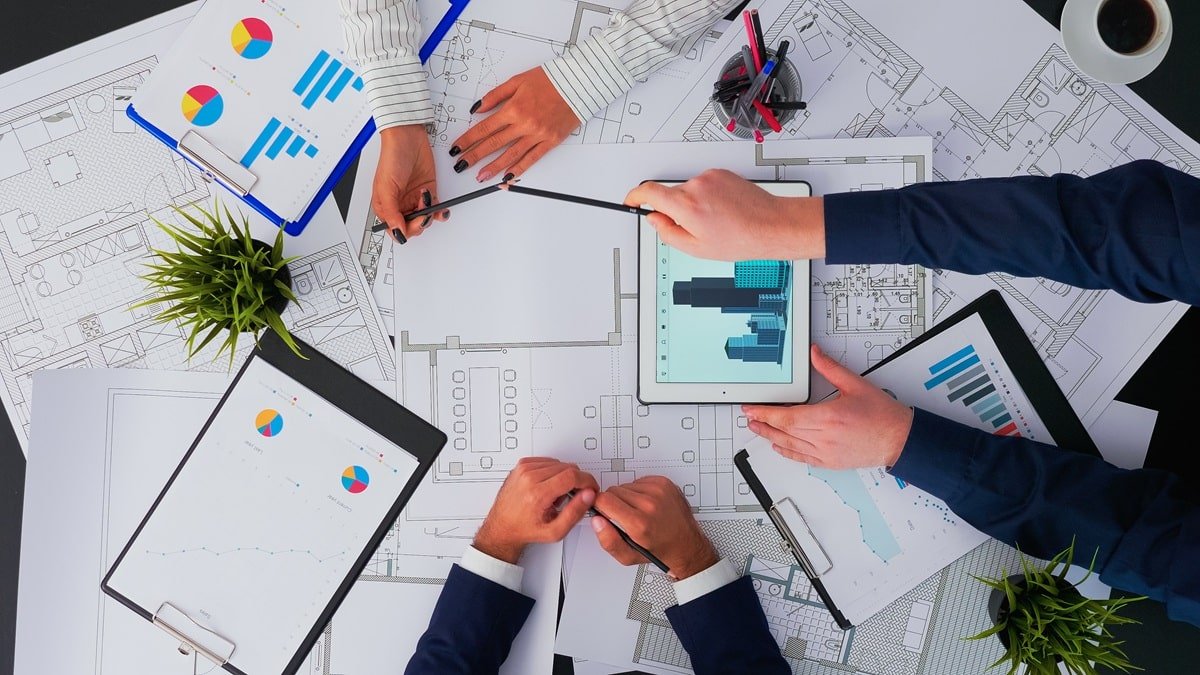 top-view-architects-interior-designers-meeting-inspecting-concluding-with-blueprint-change-renovation-project-min