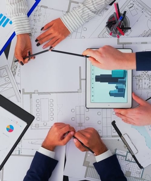 top-view-architects-interior-designers-meeting-inspecting-concluding-with-blueprint-change-renovation-project-min